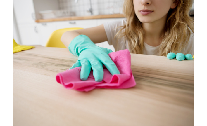 Midsection Of Young Woman Cleaning Table At Home