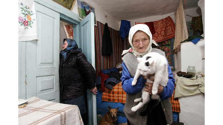 Widow Zina Guzienko, 93, holds her cat w