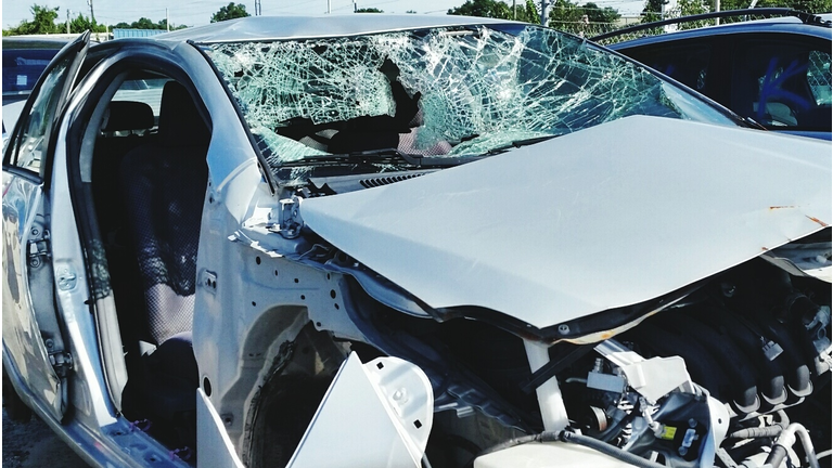 Damaged Car In Parking Lot