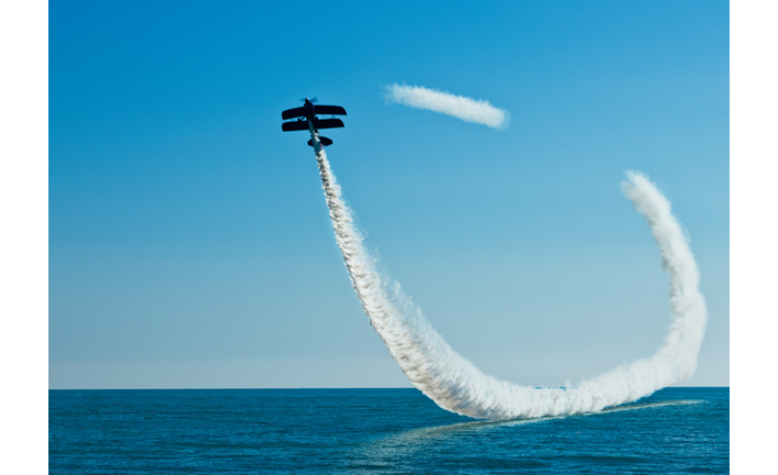Aerobatic biplane on the sky