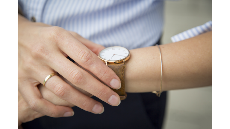 Businesswoman wearing wrist watch, close-up