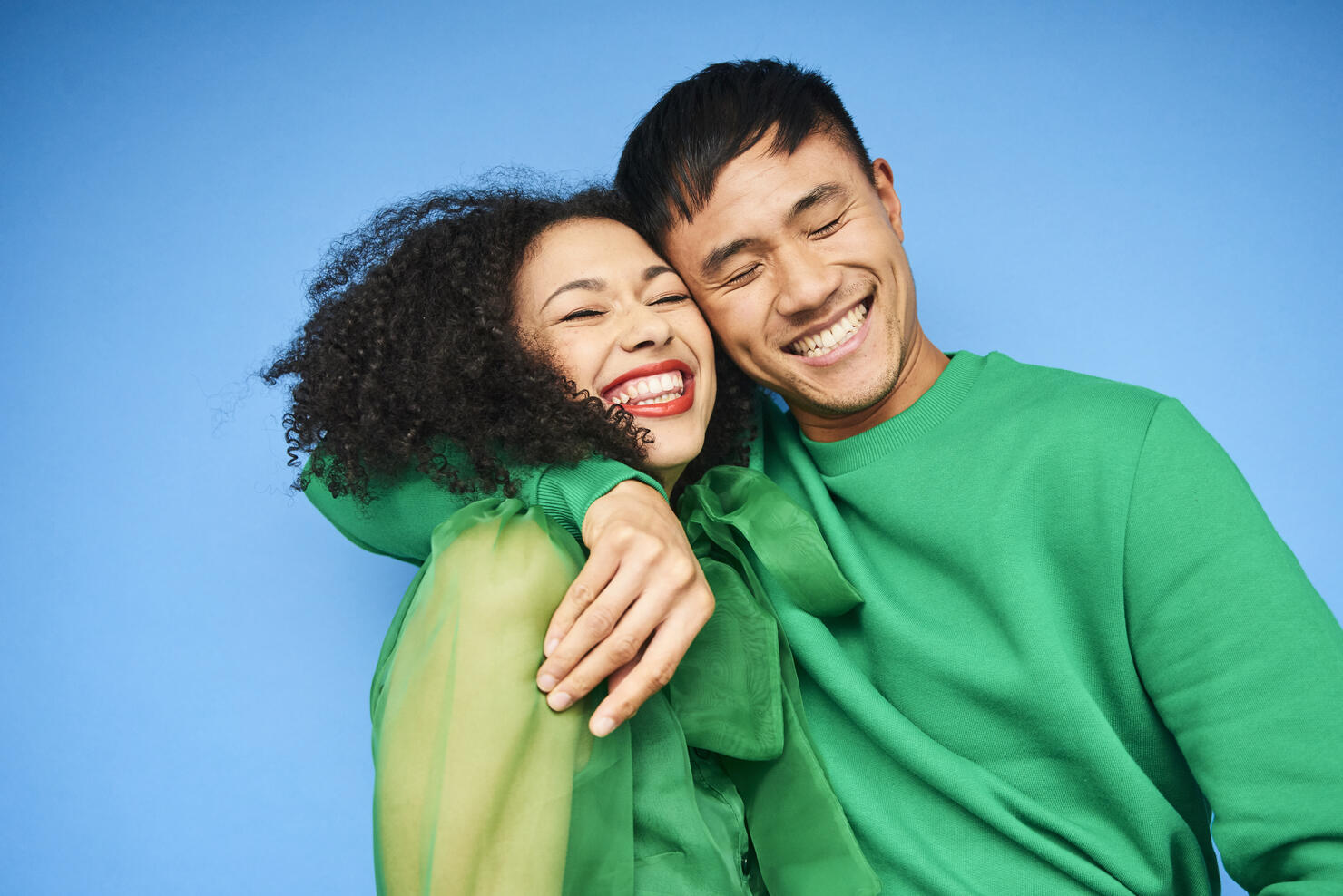 Colourful studio portrait of a young woman and man