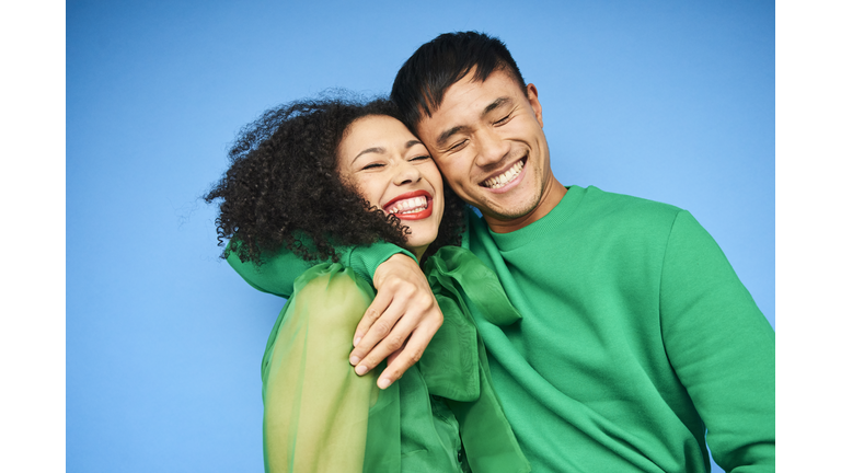 Colourful studio portrait of a young woman and man