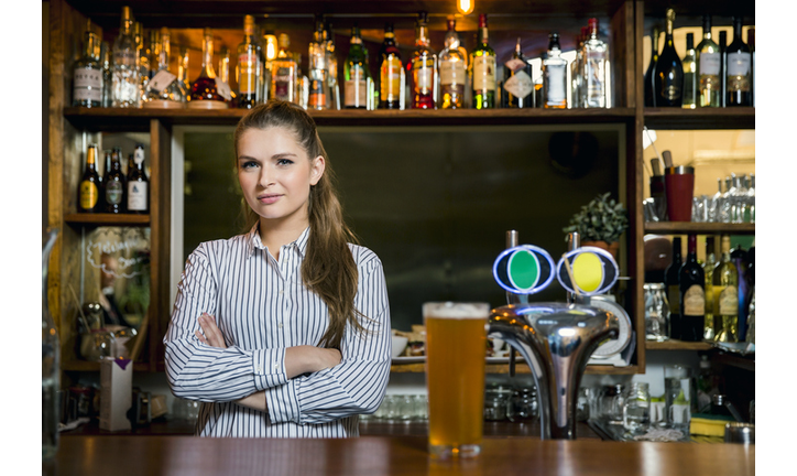 Confident bartender standing in restaurant