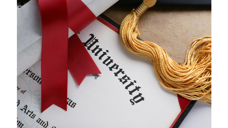 Gold tassel and rolled diploma with red ribbon
