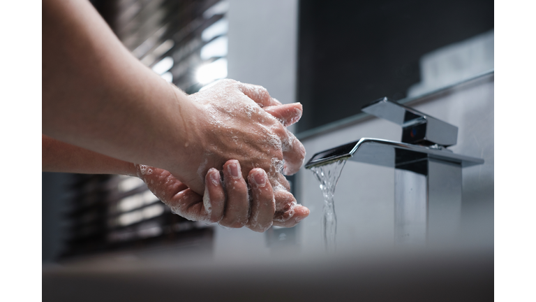 Cropped Image Of Person Washing Hands At Home