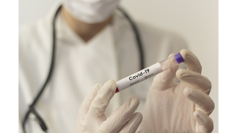 Midsection Of Doctor Holding Test Tube In Laboratory