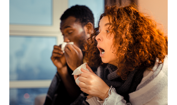 Woman feeling awful while sneezing and having running nose