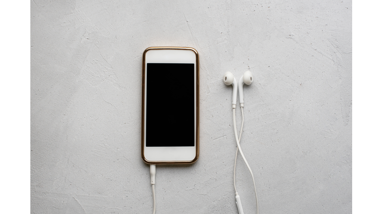 Mobile Phone and headphones on white background