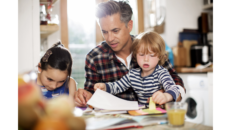 Father doing art with son and daughter