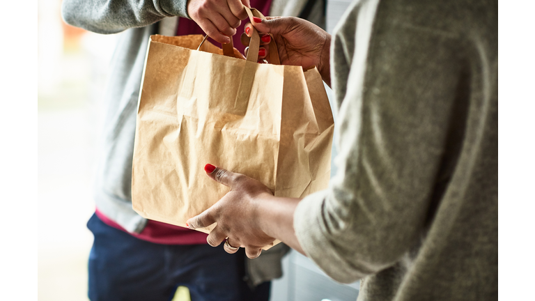 Close up of woman receiving take away food delivery