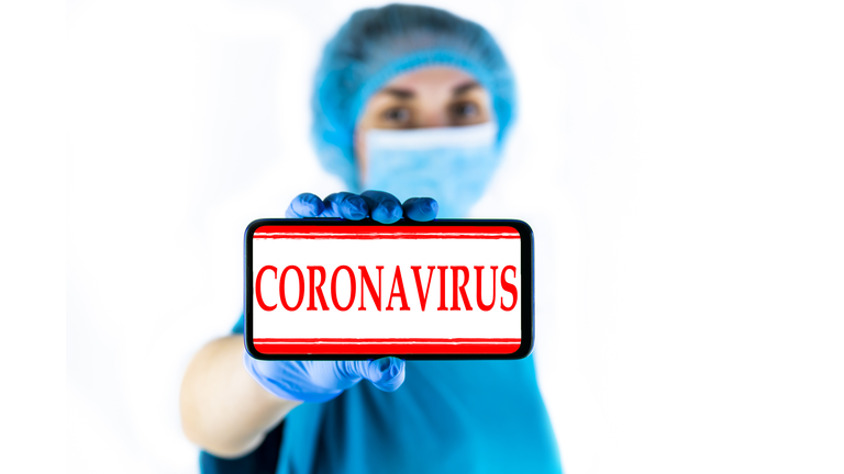 Doctor showing type of personal protection equipment she needs.