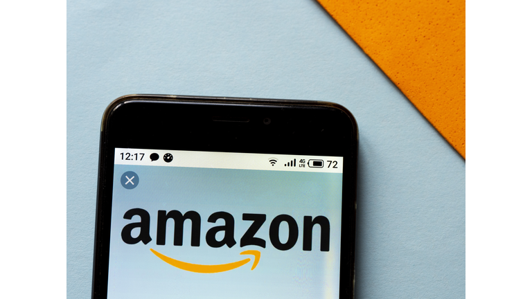 In this photo illustration an Amazon logo seen displayed on