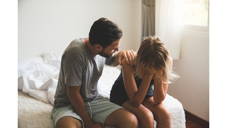 Loving husband comfort upset offended wife, caressing and hugging