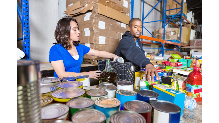 Young people volunteering to sort donations for charity food drive