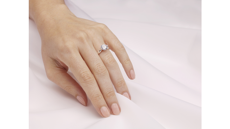 Hand of woman wearing engagement ring