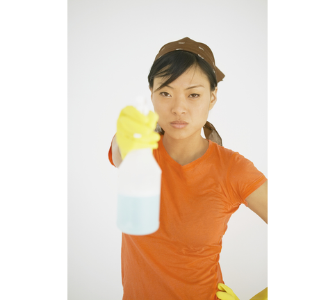 Young woman holding a spray bottle