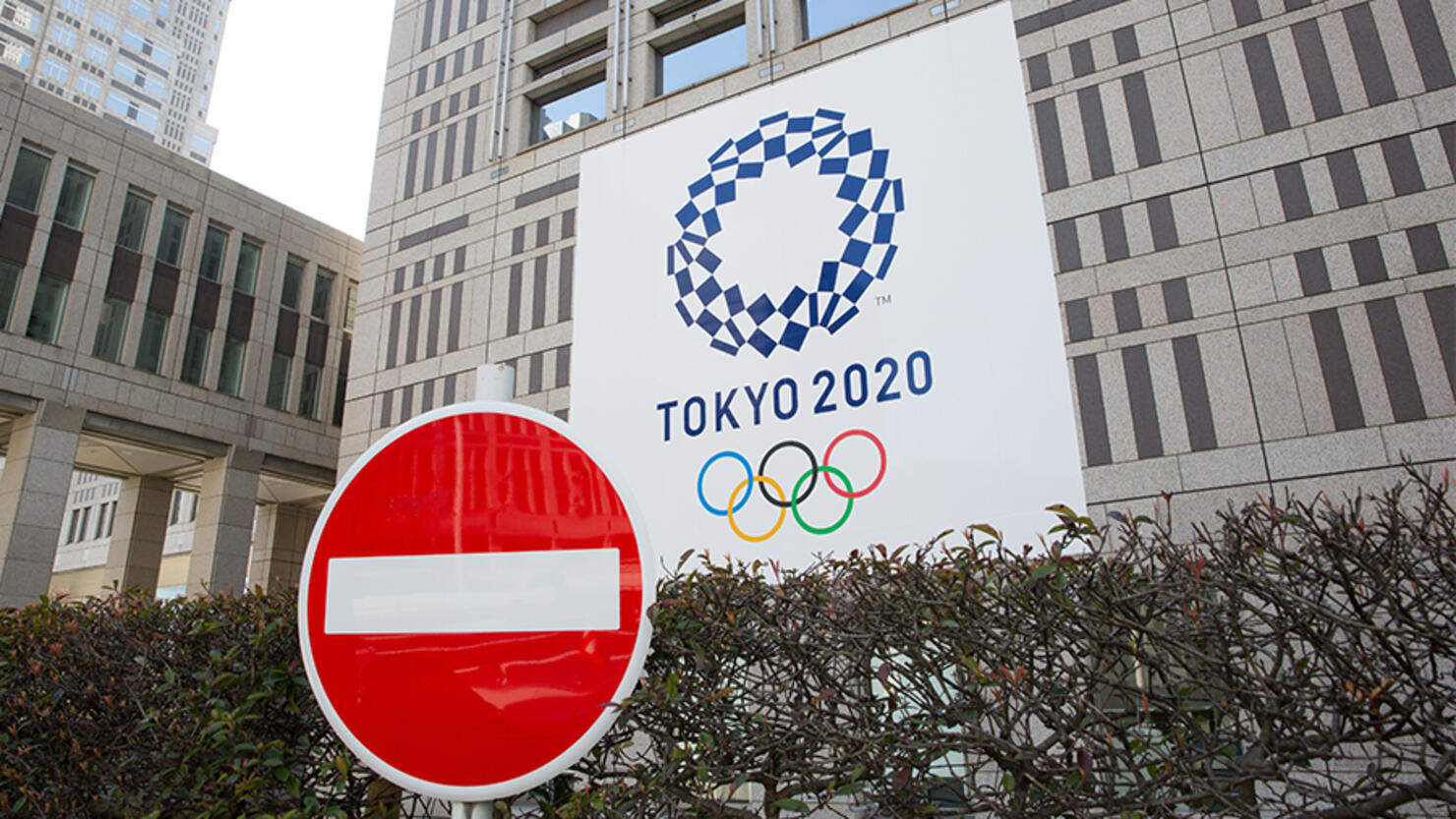 A stop sign in front of the Tokyo Metropolitan Government