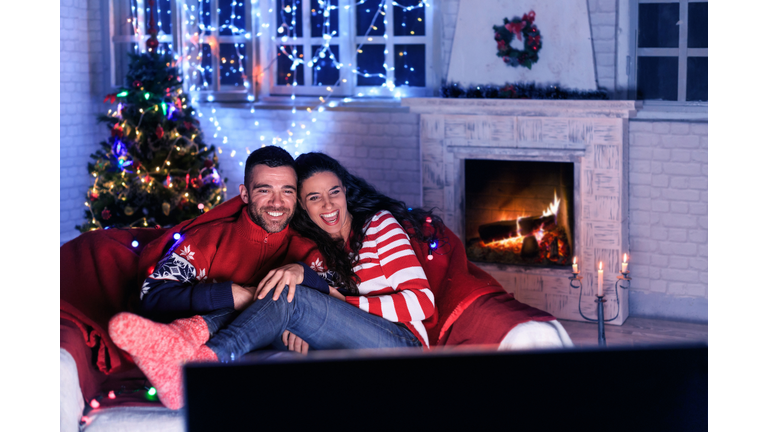 Couple watching TV at home