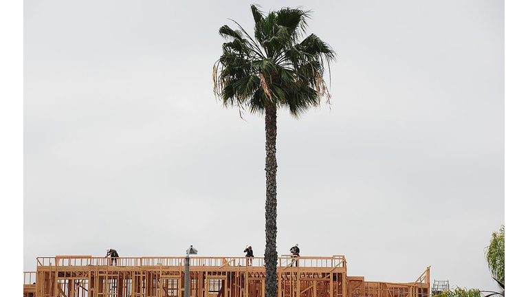 Construction workers are seen atop a bui