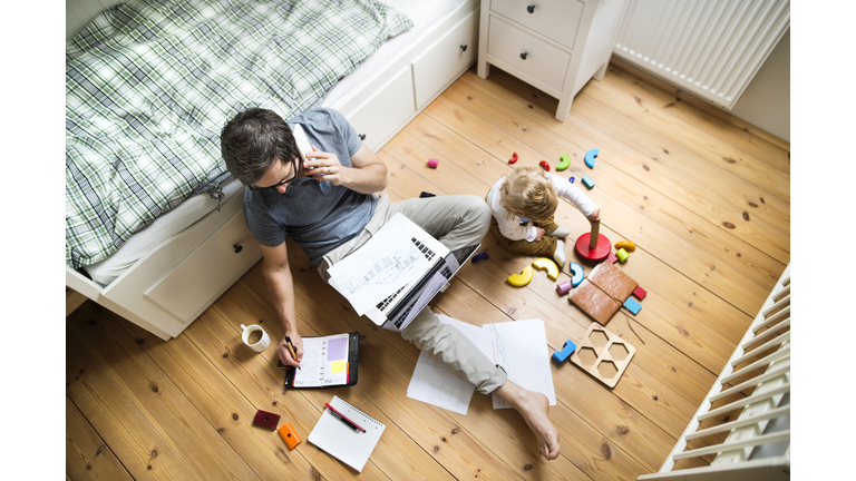 Father with his little son working from home