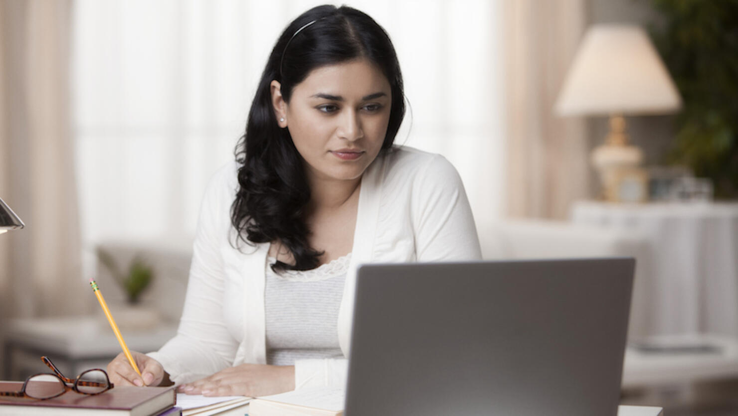 Mixed race woman studying on laptop