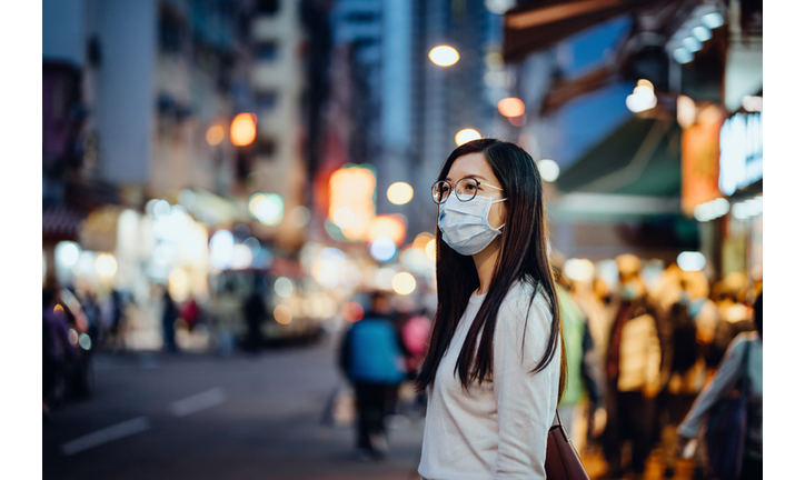 Portrait of young Asian woman with face mask to protect and prevent from the spread of viruses in the city