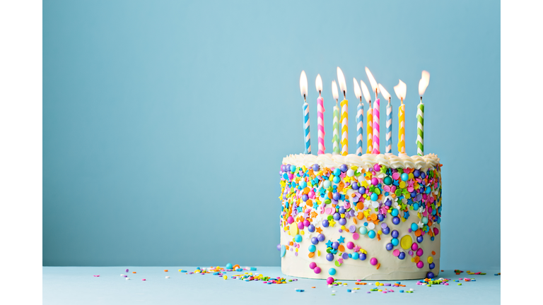 Birthday cake decorated with colorful sprinkles and ten candles