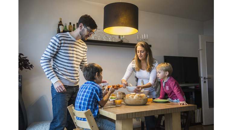 Mother serving food to her family, Munich, Germany