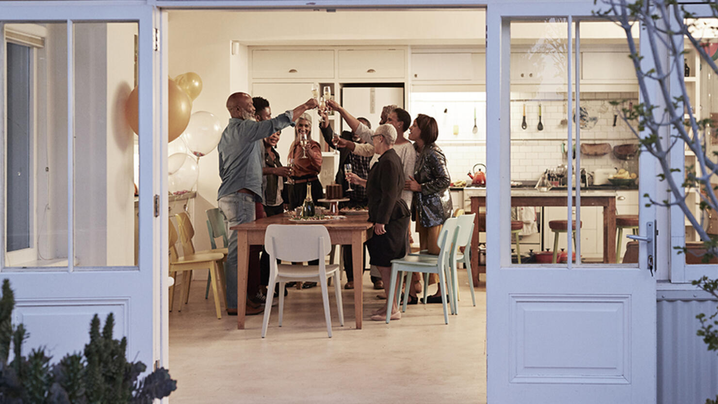 Family toasting drinks during birthday party