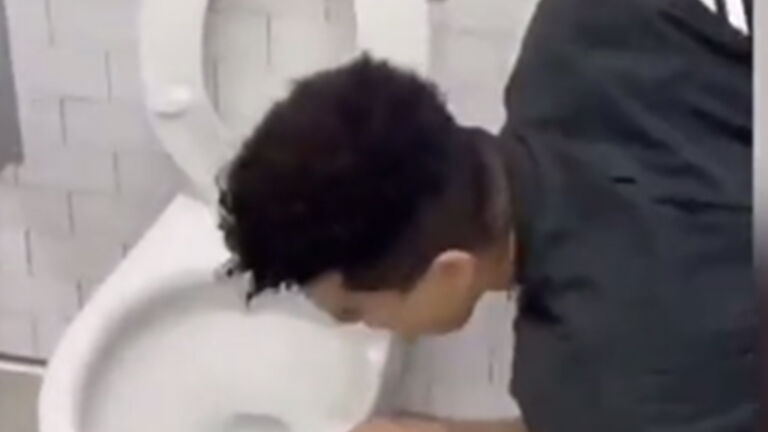 Social media influencer licks a public toilet