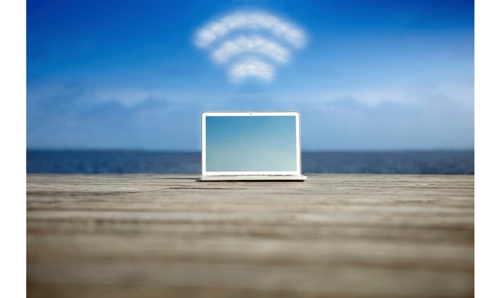 Laptop with wifi symbol at the coast