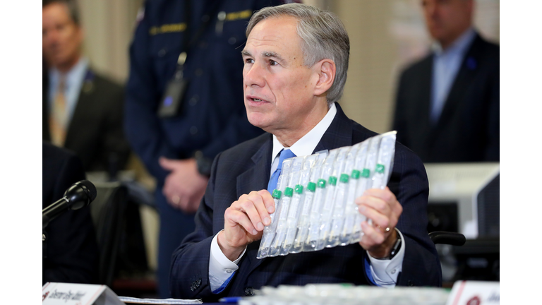 Texas Governor Greg Abbott displays COVID-19 test collection vials as he addresses the media during a press conference held at Arlington Emergency Management on March 18, 2020 in Arlington, Texas. (Photo by Tom Pennington/Getty Images)