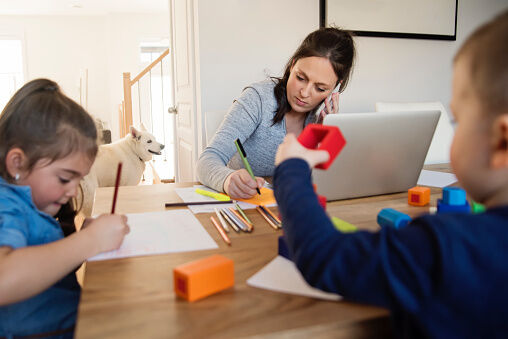 Mother working from home with young children in quarantine isolation Covid-19