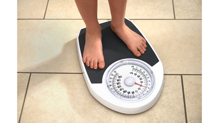 Young Obese Boy on Bathroom Scales