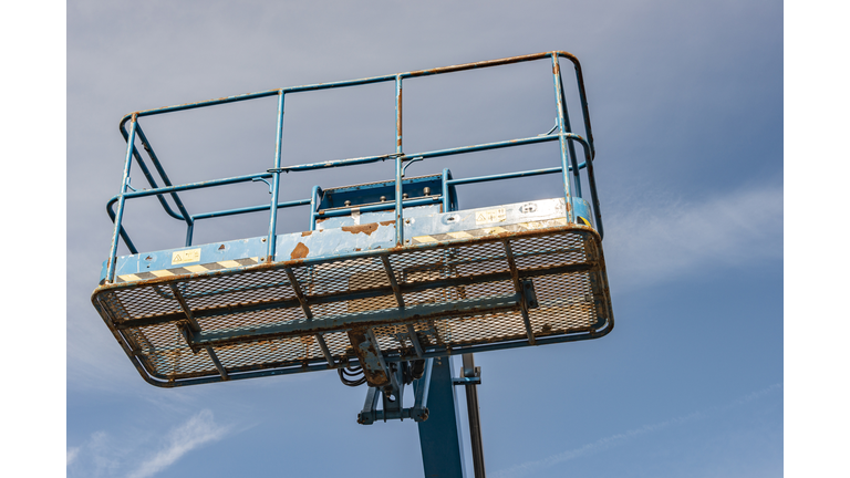 aerial platform with steel platform box against a blue sky background