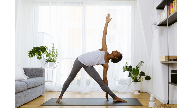 Woman practicing yoga at home