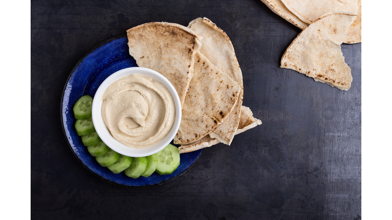 Healthy vegan snack, hummus with pita bread and cucumber