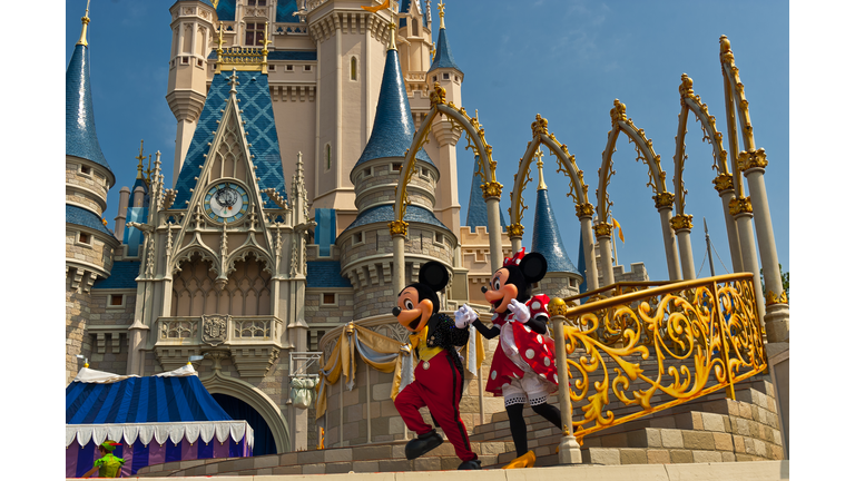 Mickey Mouse and Minnie Mouse perform in front of the Cinderella Castle