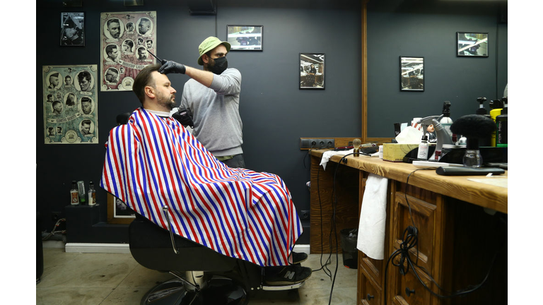 A gentleman in gets his hair cut in the Covid 19 Era