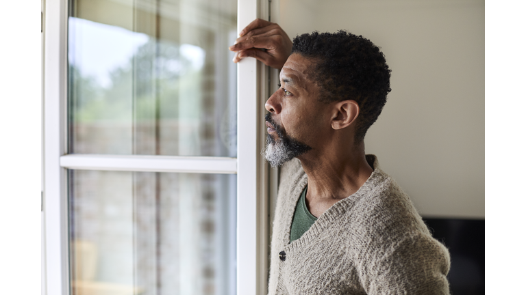 Pensive man looking out of window