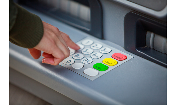 Cropped Hand Of Man Using Atm