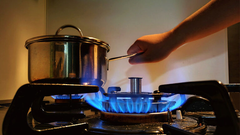 Close-Up Of Woman Preparing Food In Kitchen At Home