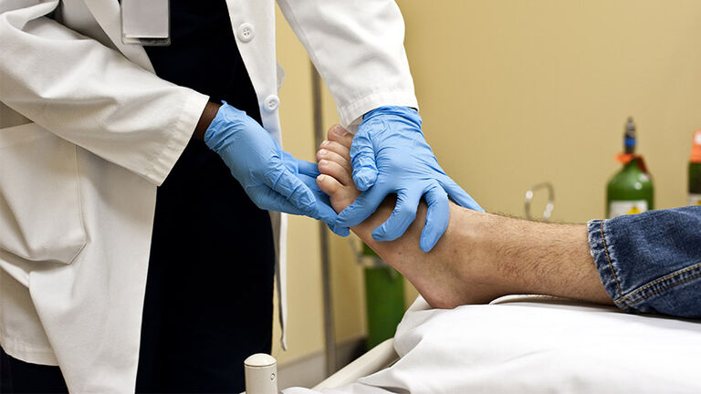 Checking the patient's foot