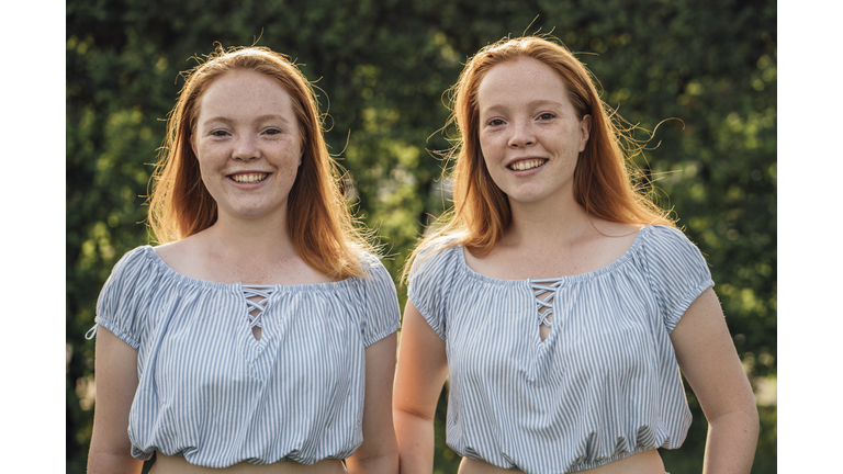 Smiling redheaded twins