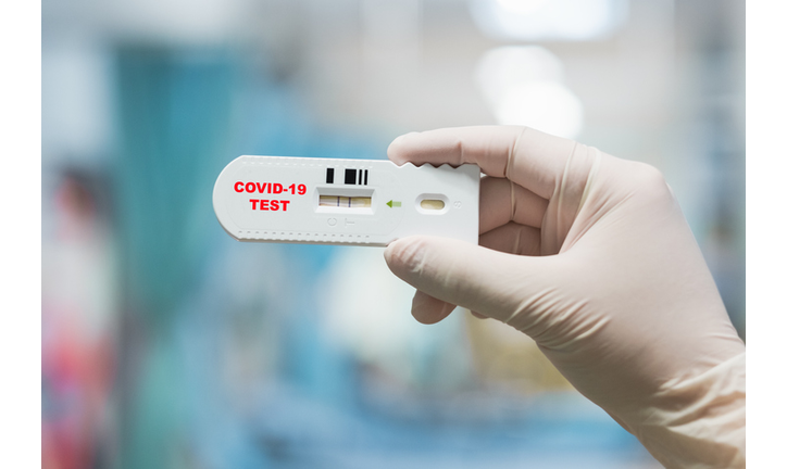 Doctor hand holding positive Coronavirus or Covid-19 rapid test