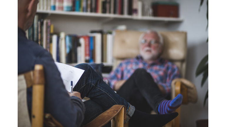 Male therapist with senior patient during therapy session