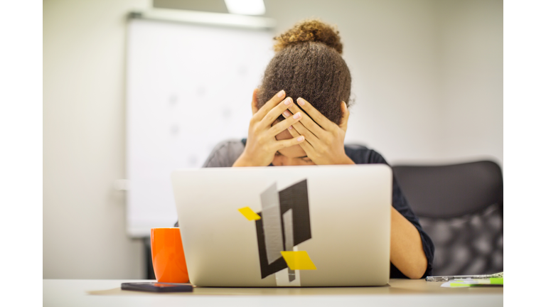 Businesswoman frustrated by bad new at office desk