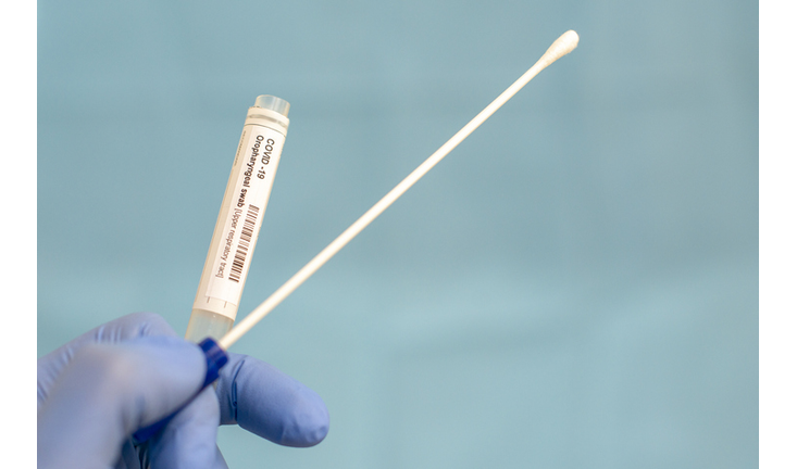 Cotton swab and test tube for Coronavirus test (COVID-19)), macro image of medical equipment in hands of healthcare professional