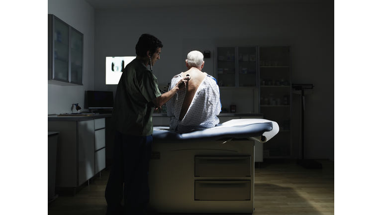 Doctor examining patient with stethoscope